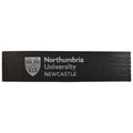 A black rectangular foam block with 'Northumbria University NEWCASTLE' and the university crest printed in white on the left side, shown against a plain white background.